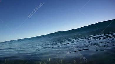 Blue Ocean Surfing Wave Breaks Over the Camera in Hawaii