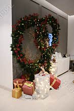 Chrismast decoration details with green leafy plants, gift boxes, owl and reindeer toy