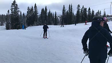 Families children and adults leisure on ski holiday,