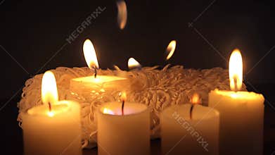 A close up of candles with the word Hijama written in cursive letters. The