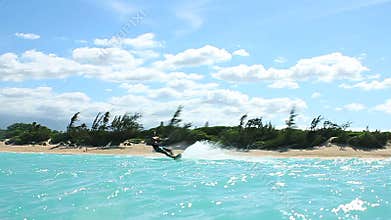 Man Kite Boarding In Ocean Doing Trick Above Camera