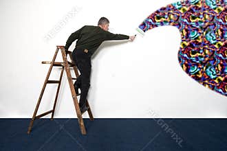 Man Painting White Wall with Wild Colors