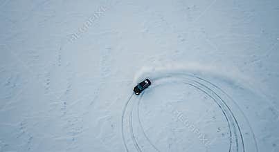 Vehicle Drifting on Snow Covered Field Aerial View From Above