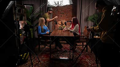 Two Influencers of women being interviewed in a loft-style podcast studio