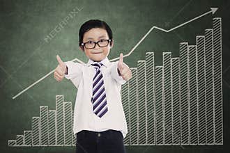 Successful little businessman over a business chart