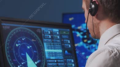 Professional air traffic controller in the control tower. Aircraft control officer works using radar, computer navigation and