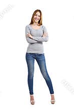 Confident full body of a casual happy woman standing wearing jeans