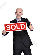 Real estate man holding a sold sign