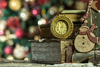 Old books and vintage clock on Christmas background.
