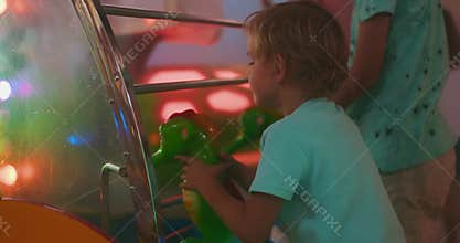 Child Playing Water Gun Game at Arcade