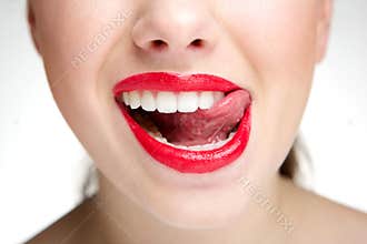 Woman licking teeth with tongue