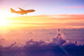 Airplane in the sky at sunrise