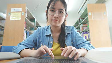 Young Woman Work On Laptop Computer Typing Point Of View At University Library