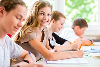 Students writing a test in school concentrating