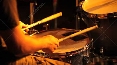 Musician in concert, hands playing the drums
