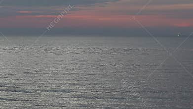 Seascape view in evening time with sea wave and orange sunset in background.