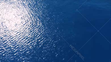 Aerial View: Sunlit Ocean Waves, Deep Blue Serenity, Sparkling Water Surface