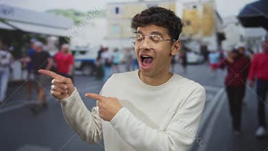 Man pointing fingers to the side on a busy urban street with mouth open; surprise excitement amazement joy