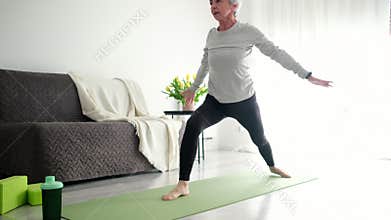 Attractive Grey-Haired Senior Woman Practicing Yoga, Doing The Downward-Facing Dog Exercise
