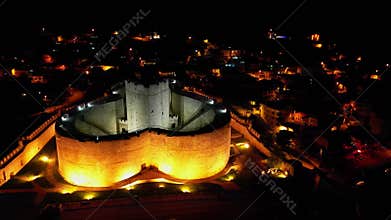 Nighttime aerial of Ottoman-era fortress in Turkiye
