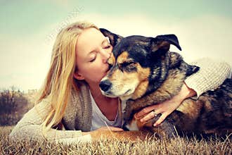 Woman Tenderly Hugging and Kissing Pet German Shep