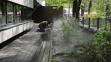 Woman turning garden sprinklers off