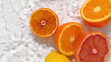 Citrus fruits falling into water