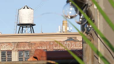 New York City industrial building exterior architecture, USA. Red brick facade. Rooftop water tower.
