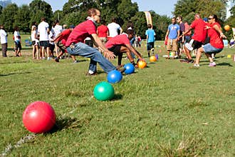 Two Teams Sprint For Balls To Begin Dodge Ball Game