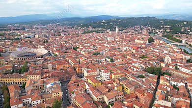 Aerial view of the city of Verona with its arena and the Adige River, and mountain in the background