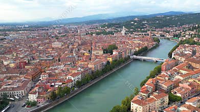 Drone view of a bridge over Adige River along the city of Verona on a sunny day in Veneto, Italy