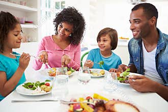 African American Family Eating Meal At Home Together
