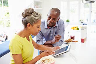 Mature African American Couple Using Digital Tablet At Home