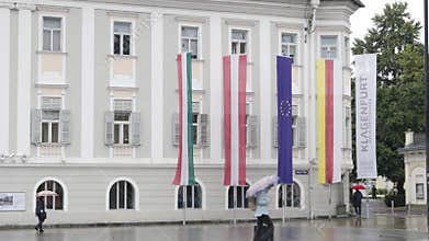 Walking in front of the city hall building (Rathaus) on a cloudy rainy day in Klagenfurt, Austria