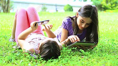 Girls having fun on digital tablet and smartphone