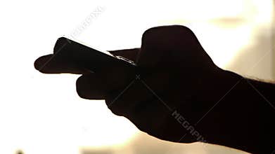 silhouette hand Calls on white background / writing text message cellphone