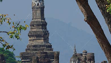 Panning view of large stone stupa with Buddha Statue