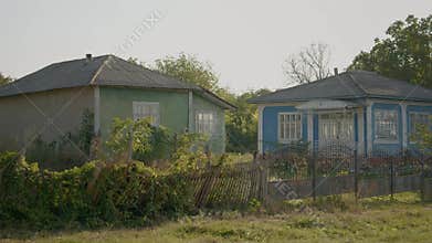 Exploring an abandoned village with deserted houses and overgrown paths
