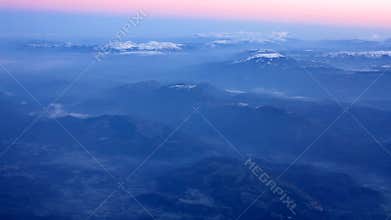 Fly above mountain during sunrise