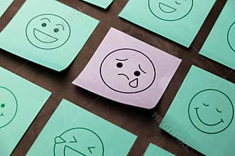 Mind, Mental Health Concept. Mood and Emotion on Sticky Note. Sadness Cartoon Emoticon Face at the center, surrounded by another