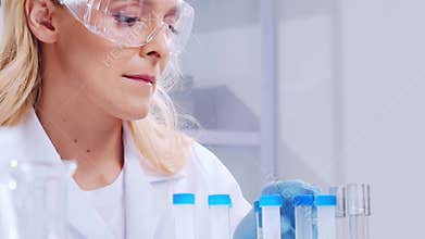 Scientific laboratory filled with various research equipment. Scientists are conducting experiments and research