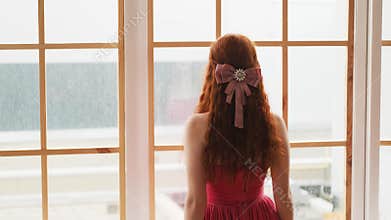Art beautiful charming woman turned away looking out old window video footage 4k
