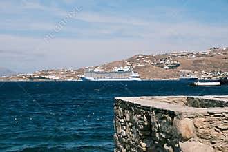 Scenic View of Mykonos Port with A Cruise Ship in the Background