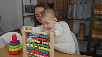 Mother and baby playing with abacus toys in living room with visible love and warmth in their family interaction