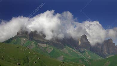 Caucasus mountains under moving clouds