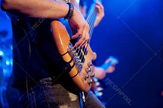 Young man playing bass live. Body.