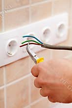 Electrician hands with wires and pliers