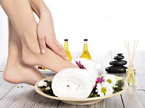 Female feet at spa salon on pedicure procedure