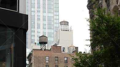 New York City building architecture. Residential house exterior. USA real estate. Rooftop water tower