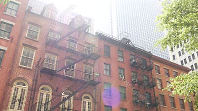New York City building architecture, Manhattan. Residential house exterior. Red brick, fire escape.